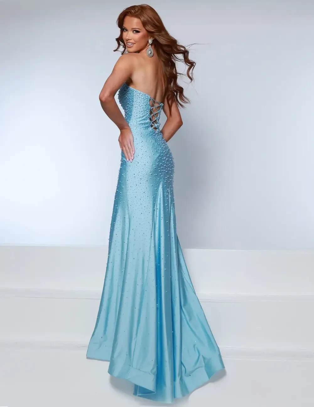 model is wearing a light blue strapless fitted prom dress
