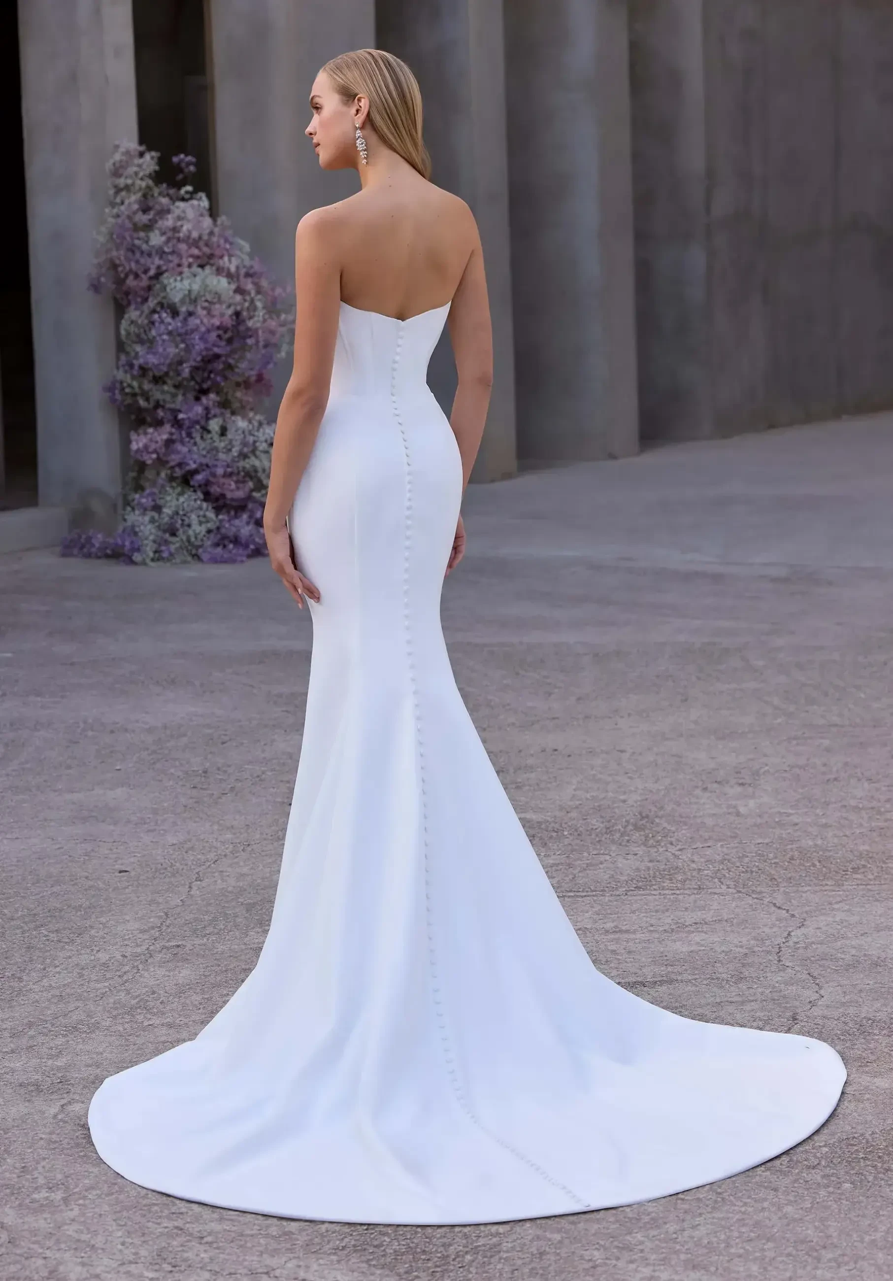 model is wearing a strapless fitted basque waist wedding dress