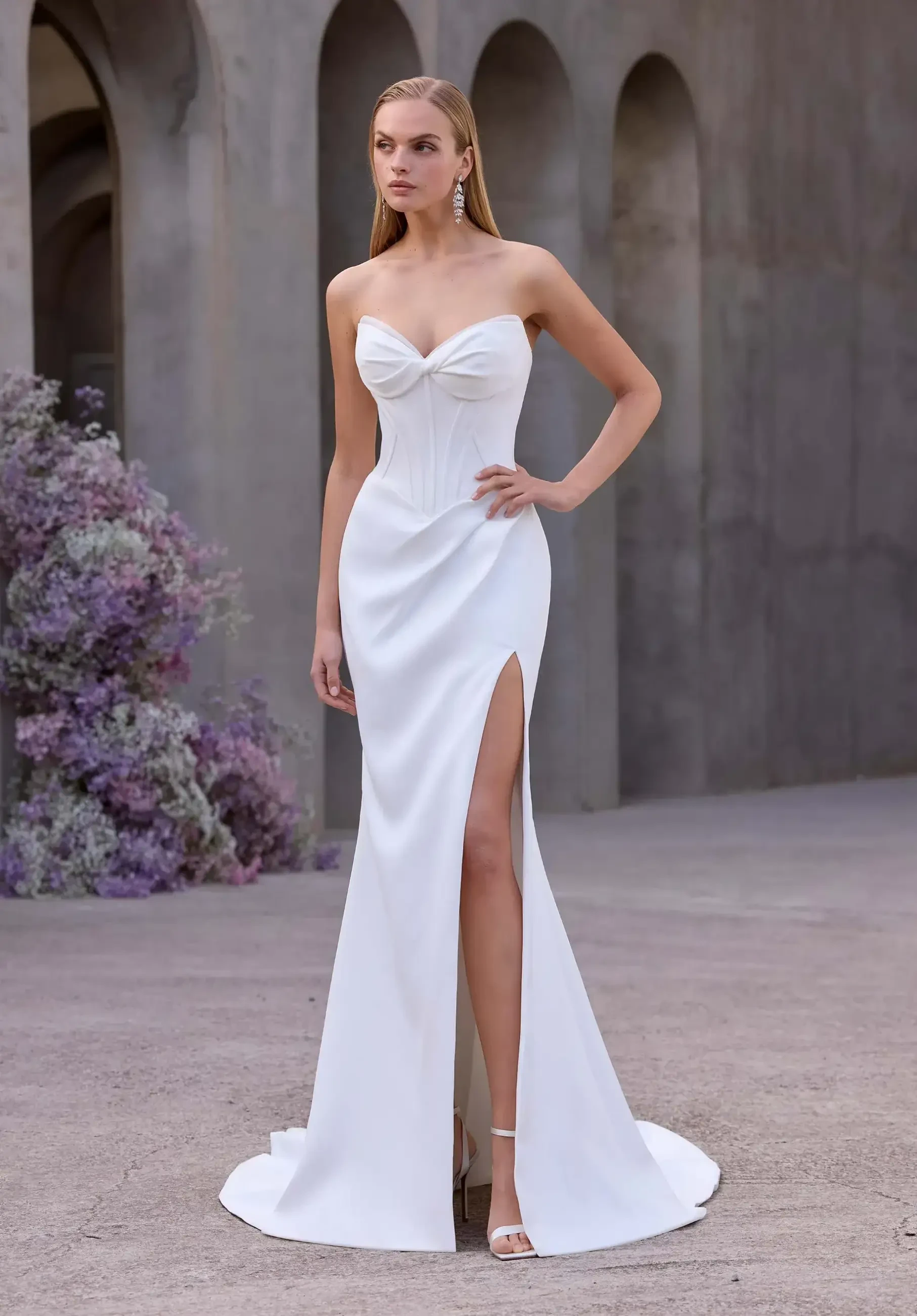 model is wearing a strapless fitted basque waist wedding dress