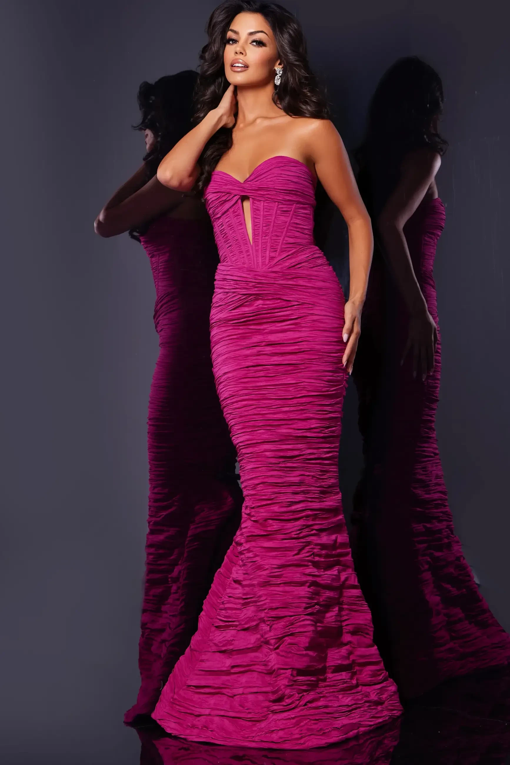 model is wearing a strapless pink mermaid prom dress