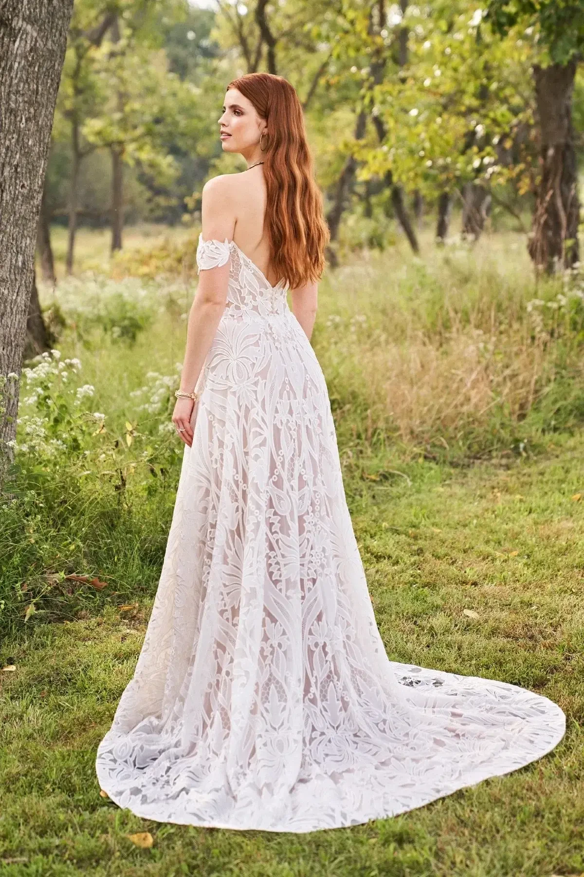 Model is wearing an ethereal off-the-shoulder A-line gown with all-over laser-cut chiffon lace.