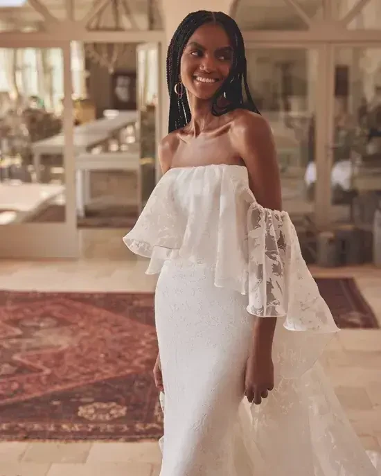 model is wearing an off the shoulder a-line wedding dress