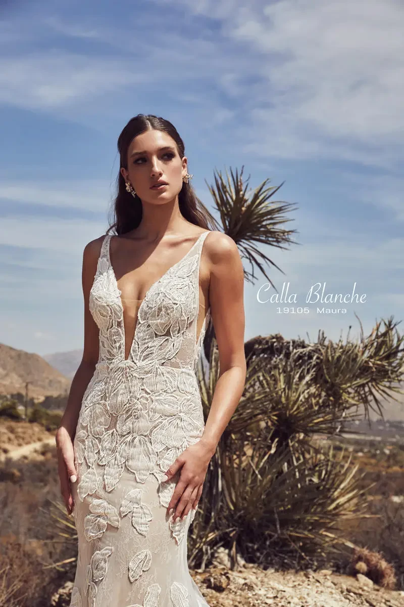 Model is wearing a boho-style fit-and-flare gown adorned with oversized floral lace.
