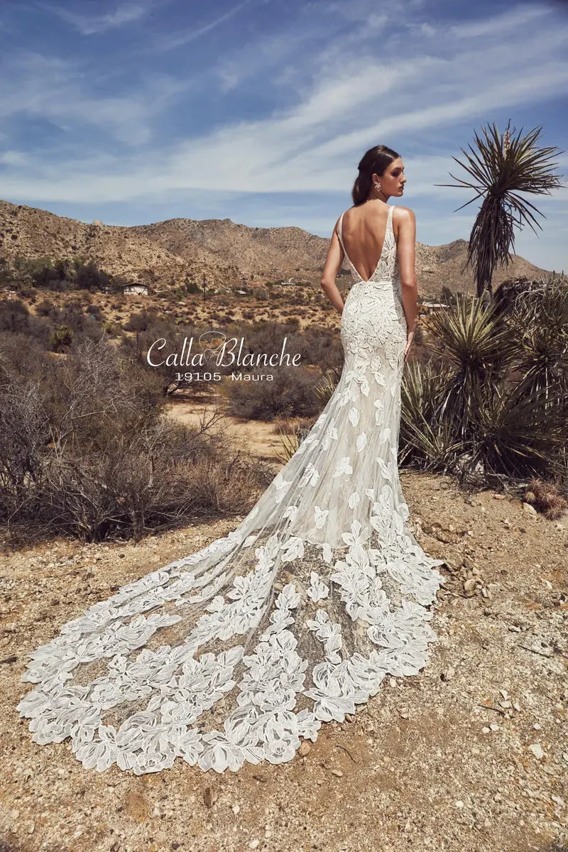Model is wearing a boho-style fit-and-flare gown adorned with oversized floral lace.