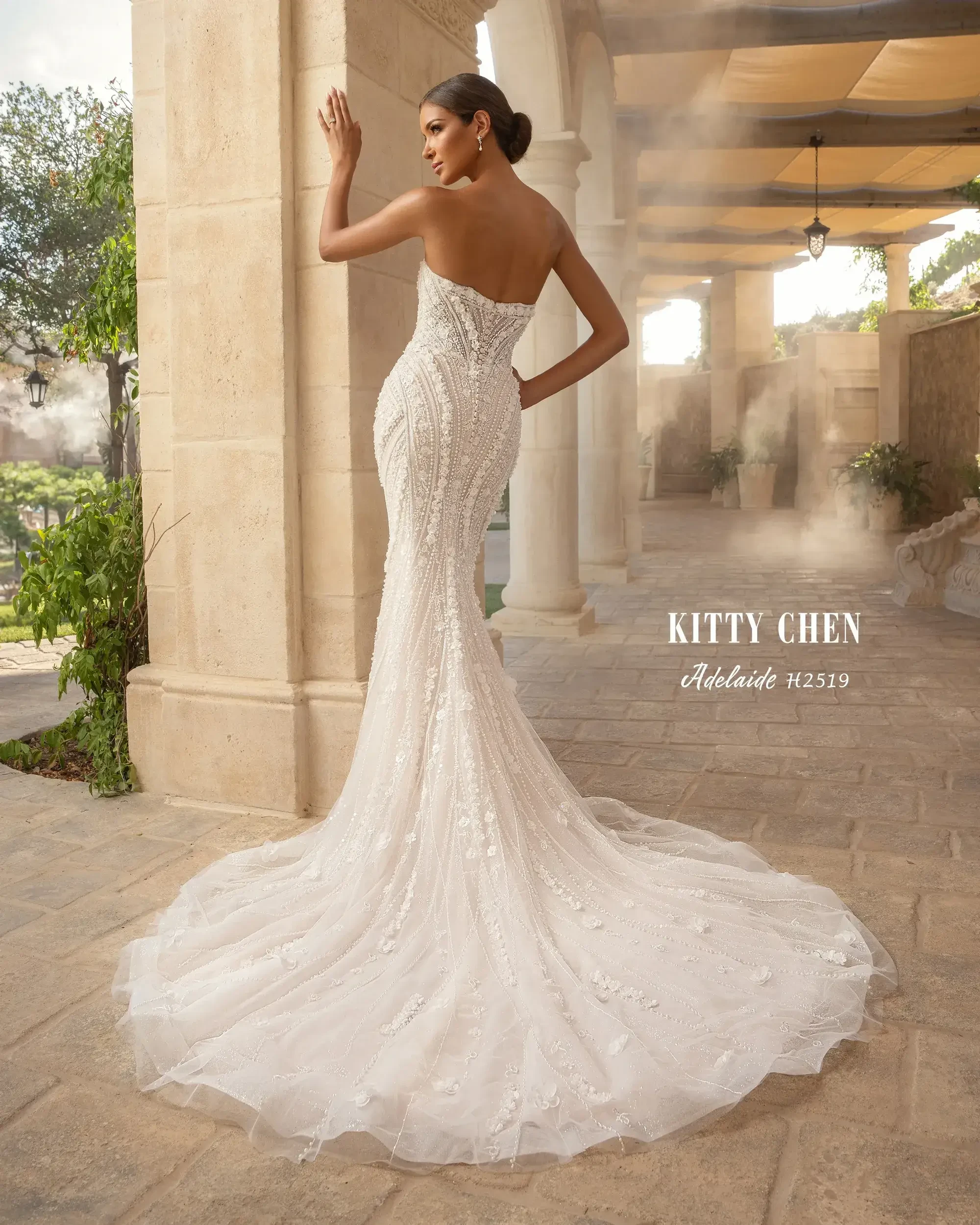 model is wearing a strapless fitted wedding dress